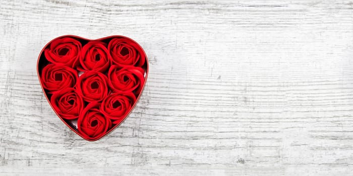 Red roses in a heart-shaped box
