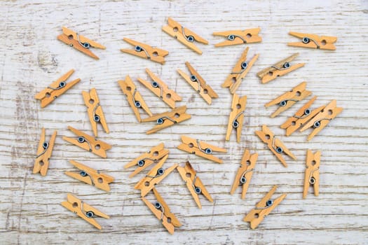 Wooden pincer on wood background