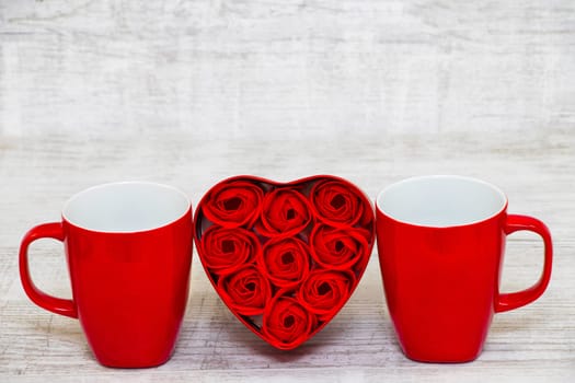 Shiny Red coffee cups and red heart roses