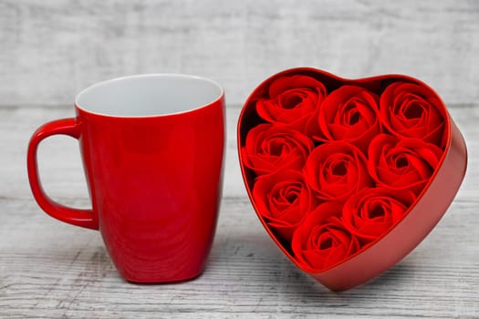 Shiny Red coffee cups and red heart roses