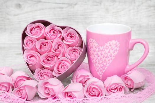 Pink porcelain coffee cup and pink heart roses