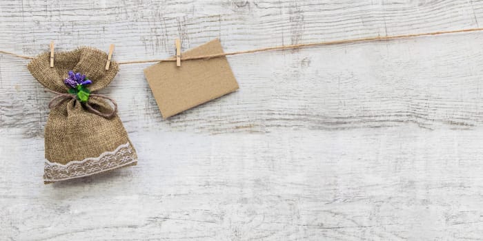 Small gift sack with heart note in wooden background