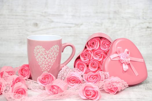 Pink porcelain coffee cup and pink heart roses