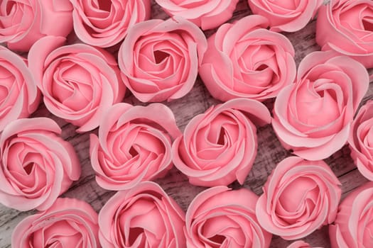 Pink roses on the wooden background