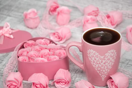 Pink porcelain coffee cup and pink heart roses