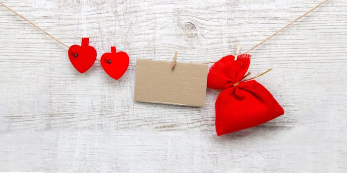 Gift sack with heart note in wooden background