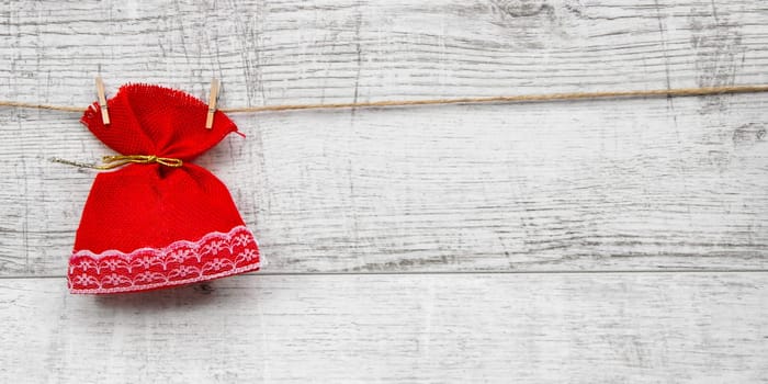 Gift sack with heart note in wooden background