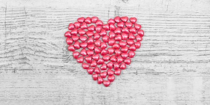 Valentines day with red heart Jellys on wooden background