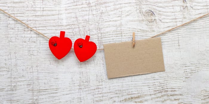 Gift sack with heart note in wooden background