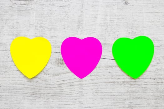 Colorful Heart Note Papers on wooden background