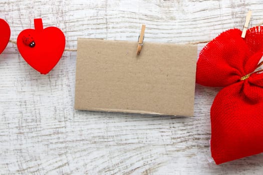 Gift sack with heart note in wooden background