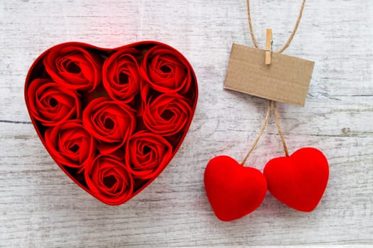 Red roses in a heart-shaped box and red Cherry Hearts