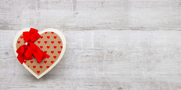 Heart-shaped box on a wooden background