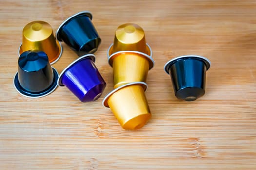 group of espresso coffee capsules with a wooden background