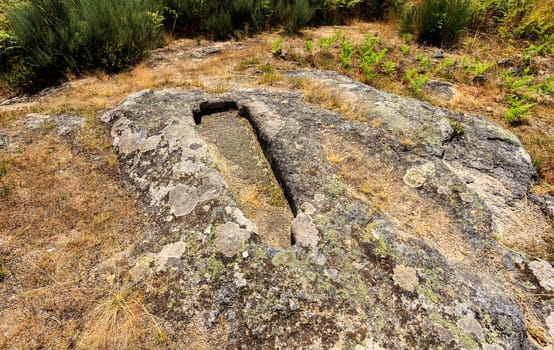 View of a granite rock cut anthropomorphic grave, body-shaped form with head and/or feet defined, at the St Gens Necropolis Site near Celorico da Beira, Beira Alta, Portugal