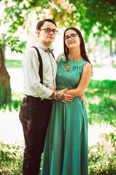 Beautiful young couple on the park background.
