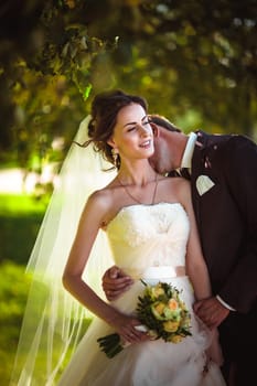 young couple groom and the bride on the park background