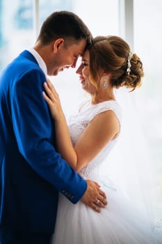 bride and groom on background clear windows.