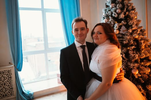 young bride and groom couple in a bright studio photo.