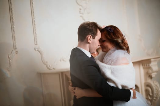 young bride and groom couple in a bright studio photo.