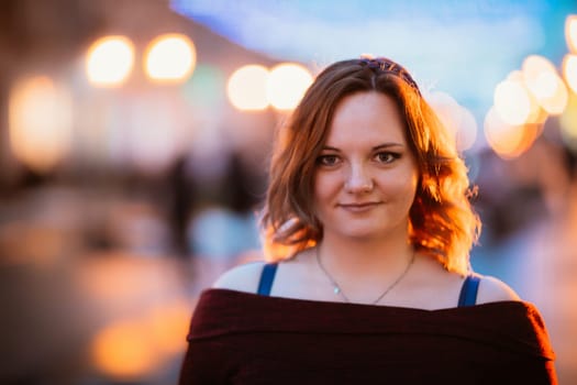 young woman posing on winter street background.