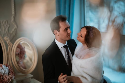 young bride and groom couple in a bright studio photo.