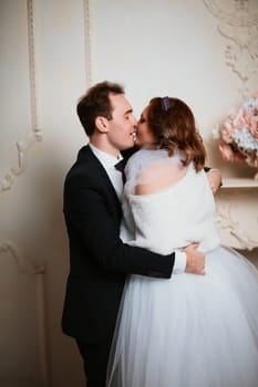 young bride and groom couple in a bright studio photo.