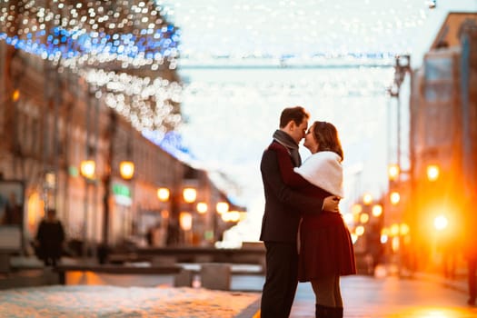 young couple on the background of the street in lanterns.