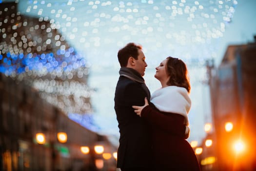 young couple on the background of the street in lanterns.