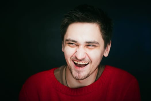 emotional young man photo in studio on blue background