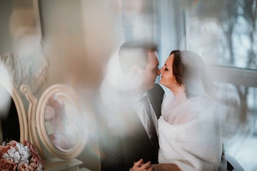 young bride and groom couple in a bright studio photo.