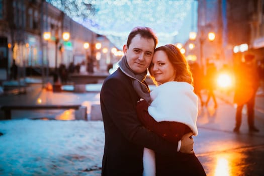 young couple on the background of the street in lanterns.