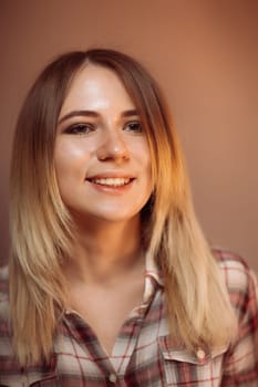 portrait smiling girl on orange background in studio.