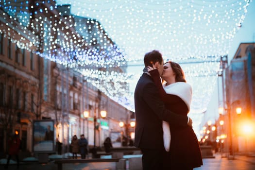young couple on the background of the street in lanterns.