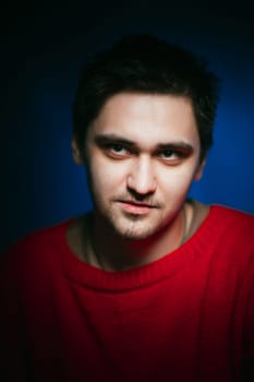 emotional young man photo in studio on blue background