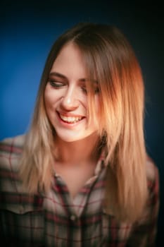 portrait smiling girl on blue background in studio.