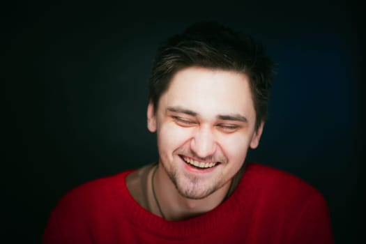emotional young man photo in studio on blue background