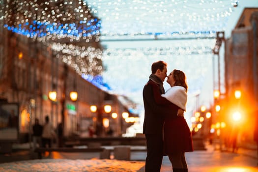 young couple on the background of the street in lanterns.