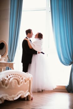 young bride and groom couple in a bright studio photo.