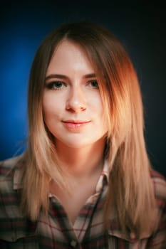 portrait smiling girl on blue background in studio.