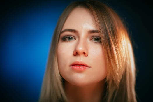 portrait smiling girl on blue background in studio.