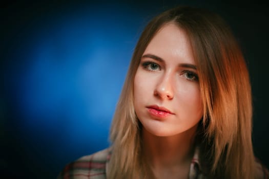 portrait smiling girl on blue background in studio.