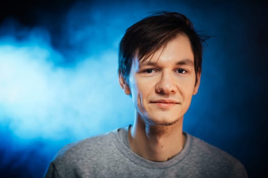 portrait emotional young man on blue background.