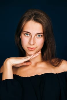 Portrait beautiful girl on a dark studio background.
