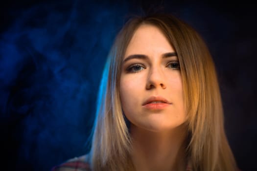 portrait smiling girl on blue background in studio.