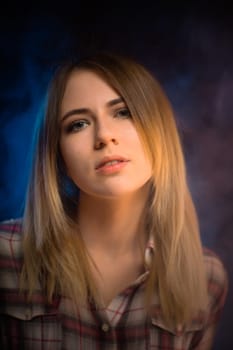 portrait smiling girl on blue background in studio.