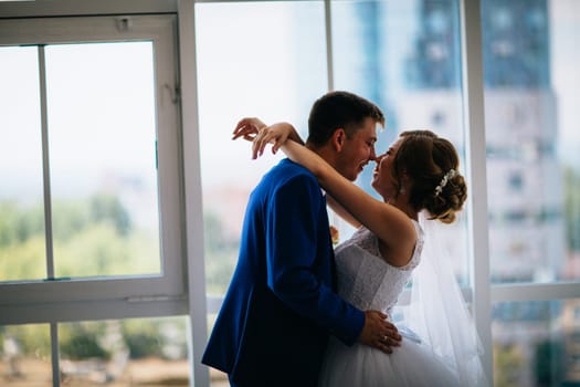 bride and groom on background clear windows.