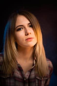 portrait smiling girl on blue background in studio.