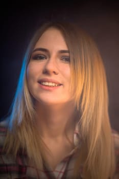 portrait smiling girl on blue background in studio.