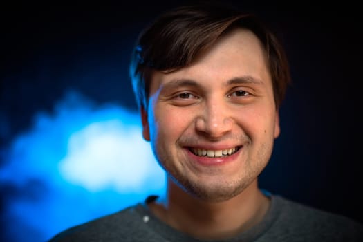 portrait emotional young man on blue background.
